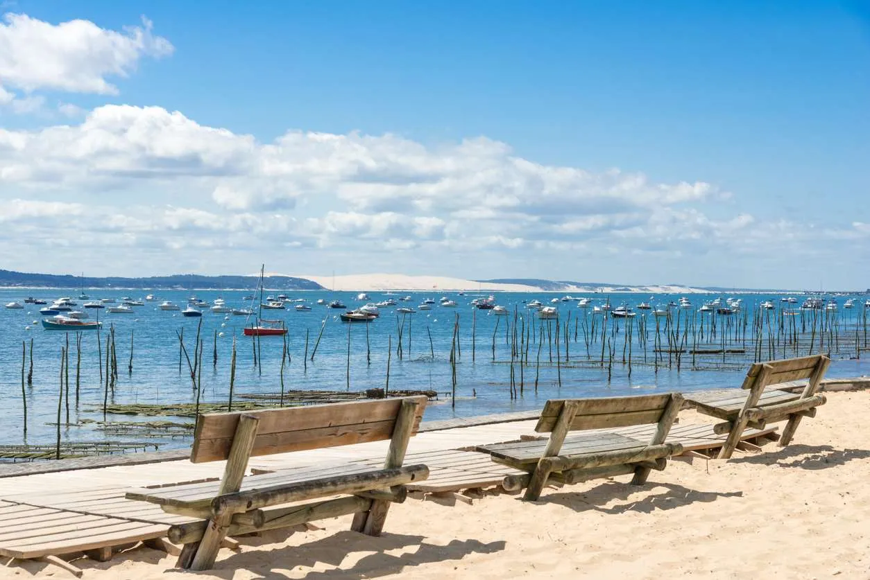 Cap Ferret (Arcachon Bay, France), public benches on the Beach of L'Herbe facing the dune of Pilat
